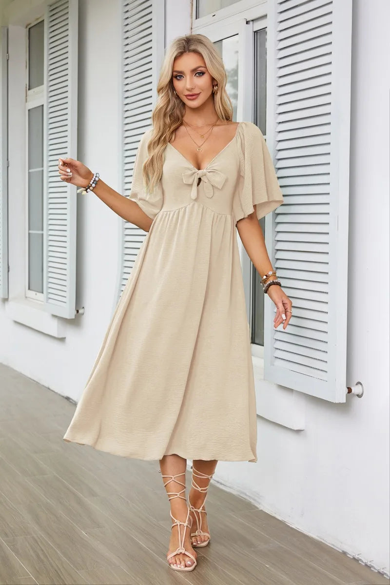 2025 Spring/Summer Women's Dress Fashion New V-neck Bow Fold Medium Length Short Sleeved Dress Printed Holiday Beach Long Dress