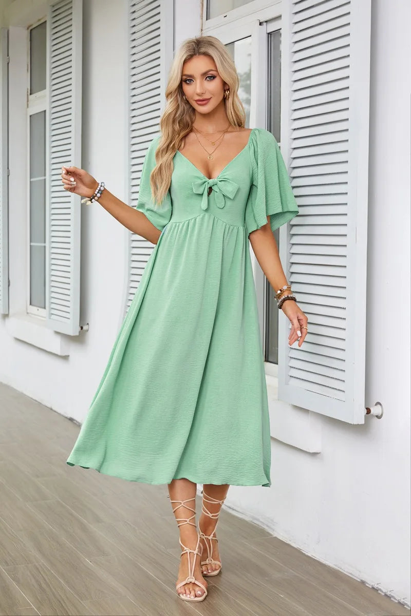 2025 Spring/Summer Women's Dress Fashion New V-neck Bow Fold Medium Length Short Sleeved Dress Printed Holiday Beach Long Dress