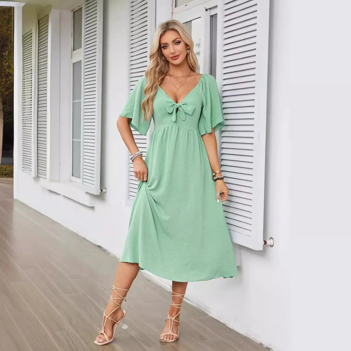 2025 Spring/Summer Women's Dress Fashion New V-neck Bow Fold Medium Length Short Sleeved Dress Printed Holiday Beach Long Dress